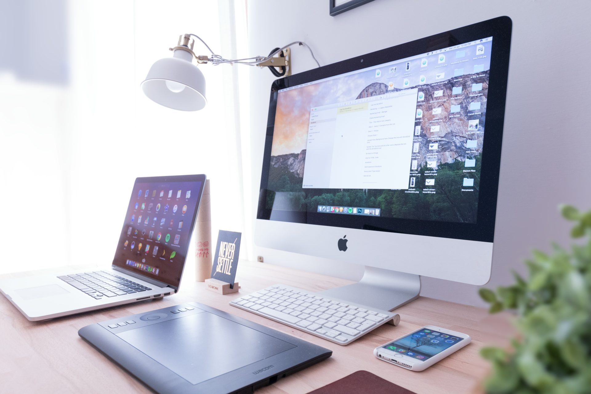 Home workspace with desktop, laptop, and tablet.