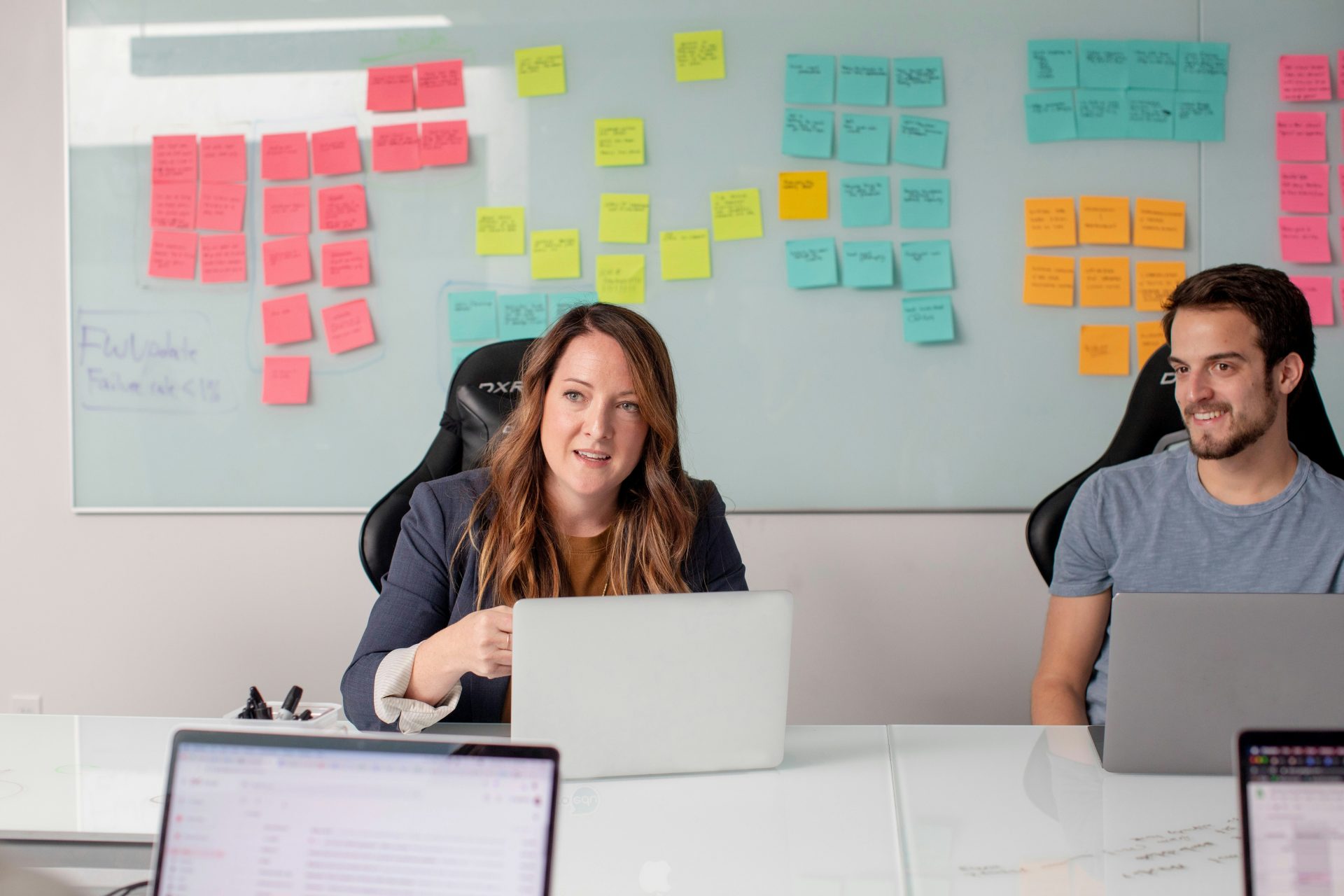Team collaborating in office with sticky notes.